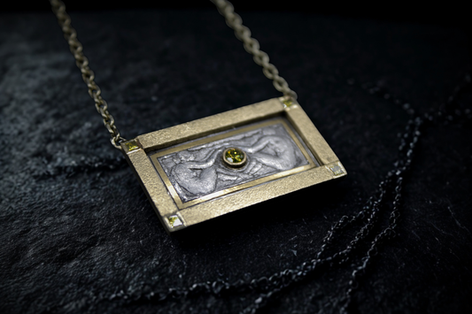 Necklace with a rectangular pendant on a dark textured surface