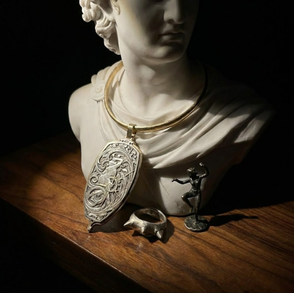 Bust of a classical figure with jewelry on a wooden surface