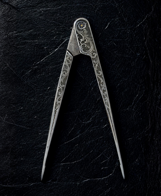 Decorative metal compass on a dark textured surface